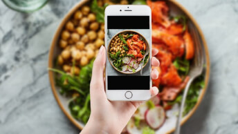Person taking a picture of healthy meal with a cellphone